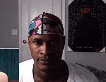 a man wearing a headband looks at the camera in front of a poster that says spiritual