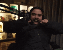 a man with a beard wearing headphones and a microphone that says jbl
