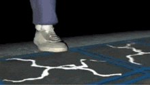 a person 's foot is standing on a cracked concrete floor .