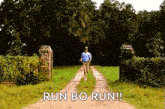 a man is running down a dirt road with the words `` run bo run '' written on it .