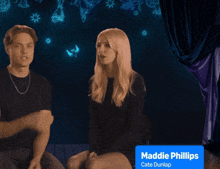 a man and a woman sitting next to each other with maddie phillips cate dunlap