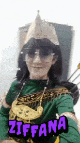 a woman in a green costume with a purple sticker that says ziffana on it
