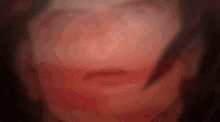 a close up of a woman 's face with a blurred background