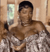 a woman in a very revealing dress is sitting on a couch in a living room .