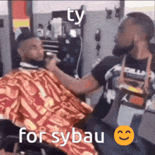 a man is getting his beard shaved by a barber with the caption ty for sybau