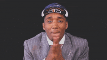 a man wearing a hat that says utah jazz is clapping