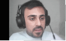 a man with a beard is wearing headphones