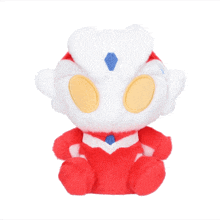 a red and white stuffed animal with a heart on it 's back