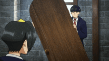 a man in a suit is holding a wooden door while another man looks on