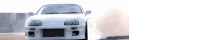 a white car is driving down a road with smoke coming out of the tires