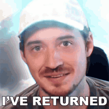 a man wearing a hat with the words i 've returned written below him