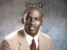michael jordan is wearing a suit and tie and says stop it .