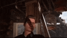 a man in a police uniform is talking on a walkie talkie in a dark room .