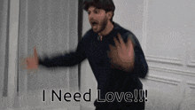 a man in a black sweater is saying i need love !!!