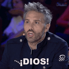 a man with a beard has the word dios on his shirt