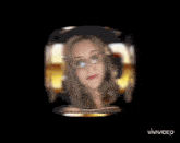 a woman wearing glasses and a headset is in a circle with the word gab on it .