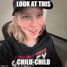 a girl wearing a black hoodie that says carolina on it