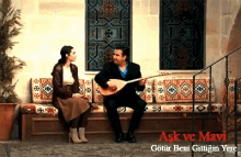 a man is playing a guitar while a woman sits on a couch with the words ask ve mavi written above them