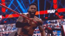 a man in a wrestling ring with the word raw on it