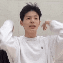 a person wearing a white sweatshirt that says inc on the front