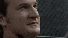 a close up of a man 's face with a slight smile on his face