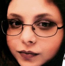 a close up of a woman wearing glasses