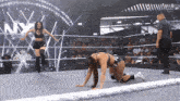 two women in a wrestling ring with the words worlds collide behind them