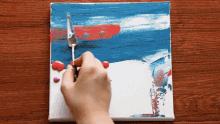 a person is painting a picture with a spatula