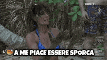 a woman in a bikini says " a me place essere sporca "