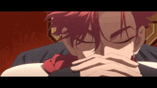 a man with red hair has his eyes closed and his hands on his face