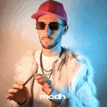 a man wearing sunglasses and a fur coat has the word mcdh on the bottom right