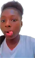 a young girl sticking her tongue out while wearing a white shirt with a logo on it