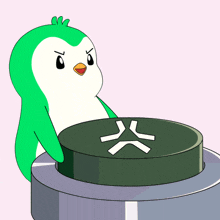 a green and white penguin is sitting on a green button with a white x on it