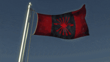 a red and black flag with an arrow in the middle