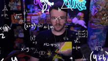 a man wearing glasses stands in front of a wall with mathematical equations and the word auke written on it
