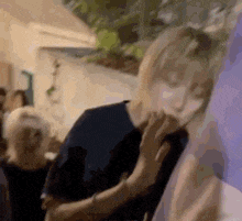 a person is touching another person 's face in a blurry picture .