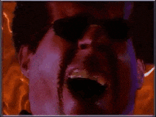 a pixelated image of a man wearing sunglasses with a purple background