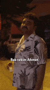 a man with a mustache is wearing a shirt that says bak tekin ahmet