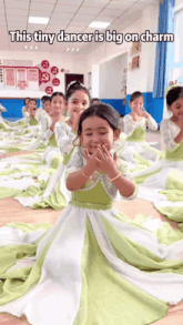 a group of young girls in green and white dresses with the caption " this tiny dancer is big on charm " on the bottom