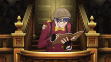 a man in a red coat and hat is reading a book
