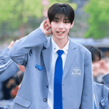 a young man wearing a suit and tie with the word boys planet on the jacket