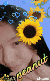 a picture of a woman with a sunflower in her hair and the word peanut below it