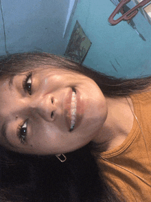 a close up of a woman 's face with her mouth open
