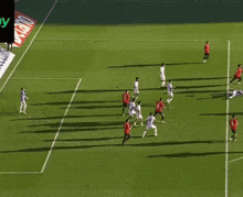 a soccer game is being played on a field with a banner behind the goal that says qualitative