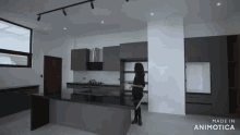 a woman stands in a kitchen with the words made in animotica on the bottom