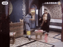 two men are standing in a room with chinese writing on the bottom
