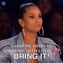 a woman in a denim jacket says show me what you working with cutie bring it