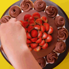 a cake with chocolate frosting and strawberries on it