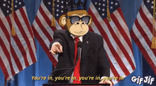 a gif of a monkey in a suit and tie pointing at the viewer