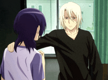 a man in a black shirt is standing next to a woman in a purple shirt